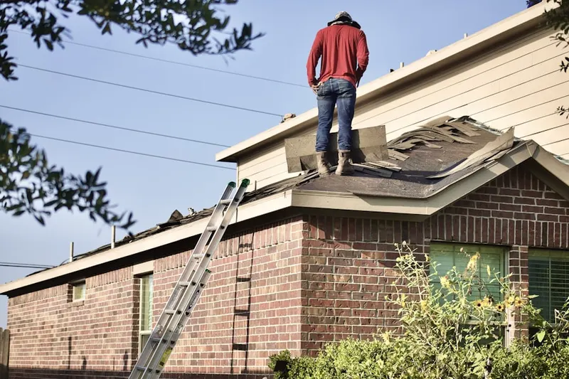 Professional roofer working on a residential roof in Breitung